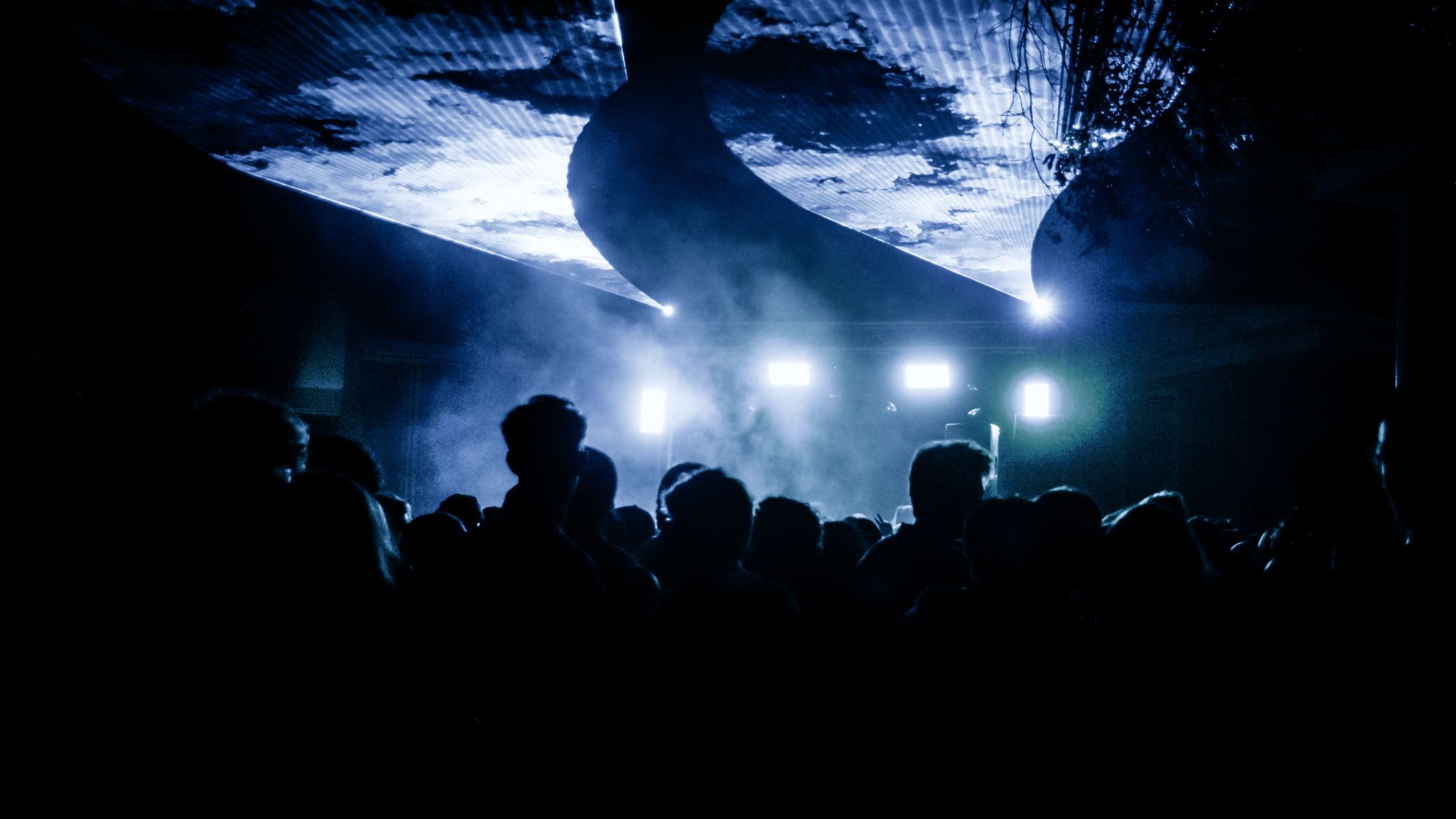 Lighting rig and haze over a packed floor